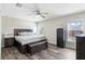Main bedroom features wood floors, neutral paint, ceiling fan, and natural light at 40143 Babb Rd, Umatilla, FL 32784