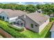 Aerial view of home's screened lanai and lush green landscaping at 4083 Capland Ave, Clermont, FL 34711