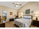 This bright bedroom has a ceiling fan, a leather recliner, and a connecting door to the bathroom at 4083 Capland Ave, Clermont, FL 34711