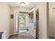 Home foyer featuring a decorated front door and view of the front yard through the screen door at 4083 Capland Ave, Clermont, FL 34711