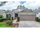 Charming single-story home with a well-manicured lawn, paver driveway, and a two-car garage at 4083 Capland Ave, Clermont, FL 34711
