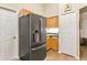 The kitchen features stainless steel refrigerator, ample cabinet space, and easy access to the pantry at 4083 Capland Ave, Clermont, FL 34711