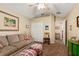 A comfy living room with a neutral sofa, ottomans, and carpeted floors at 4083 Capland Ave, Clermont, FL 34711