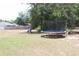 Backyard featuring a trampoline amongst the shade trees at 41 Dogwood Loop, Ocala, FL 34472