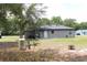 View of the home exterior featuring a propane tank and covered back porch at 41 Dogwood Loop, Ocala, FL 34472
