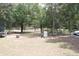 Wide backyard featuring a trampoline and gas tank surrounded by trees at 41 Dogwood Loop, Ocala, FL 34472
