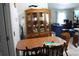 Bright dining area with wooden table, chairs, and china cabinet adjacent to living space at 41 Dogwood Loop, Ocala, FL 34472
