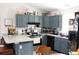 Functional kitchen featuring gray cabinets, stainless steel appliances, and breakfast bar at 41 Dogwood Loop, Ocala, FL 34472