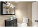 Charming bathroom featuring a vessel sink, dark vanity, and modern fixtures at 43 Almond Pass Dr, Ocala, FL 34472