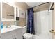 Bright bathroom featuring white fixtures and a shower with blue curtain at 43 Almond Pass Dr, Ocala, FL 34472