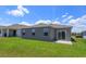 A spacious backyard with a concrete patio and well-manicured lawn at 532 Silver Palm Dr, Haines City, FL 33844