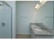 Bright bathroom featuring double sinks, granite countertop, large mirror, and glass-enclosed shower at 532 Silver Palm Dr, Haines City, FL 33844