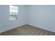 A carpeted bedroom with window and white walls at 532 Silver Palm Dr, Haines City, FL 33844