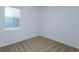 A carpeted bedroom with white walls, a window, and base trim at 532 Silver Palm Dr, Haines City, FL 33844