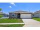 Charming single-story home featuring a two-car garage, landscaped yard, and a welcoming front entrance at 532 Silver Palm Dr, Haines City, FL 33844