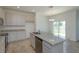 Open kitchen with stainless steel appliances and granite countertops, seamlessly connected to the backyard at 532 Silver Palm Dr, Haines City, FL 33844