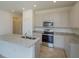 Bright kitchen featuring modern appliances, granite counters, and ample cabinet space for easy organization at 532 Silver Palm Dr, Haines City, FL 33844