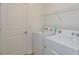 A laundry room with a washer, dryer, and storage rack at 532 Silver Palm Dr, Haines City, FL 33844