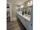 Well-lit bathroom offers double sinks, modern fixtures, and a glass-enclosed shower for a spa-like experience at 5547 Se 91St Pl, Ocala, FL 34480