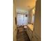 The bathroom features a vanity, a pink rug and a shower with a decorative curtain at 5547 Se 91St Pl, Ocala, FL 34480