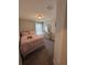 Cozy bedroom featuring a comfortable bed, dresser, and a window for natural light at 5547 Se 91St Pl, Ocala, FL 34480
