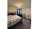 Comfortable bedroom featuring a nautical-themed bed, plush carpet, and plenty of natural light at 5547 Se 91St Pl, Ocala, FL 34480