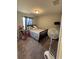 Neutral bedroom features plush carpet, a comfortable bed, and a window for natural light at 5547 Se 91St Pl, Ocala, FL 34480