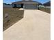Charming single-story home with a well-maintained lawn and a spacious driveway leading to an attached two-car garage at 5547 Se 91St Pl, Ocala, FL 34480