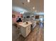 Bright, open-concept kitchen with modern island, stainless steel appliances, and seamless flow to living areas at 5547 Se 91St Pl, Ocala, FL 34480