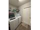 Convenient laundry room with modern Samsung washer and dryer, plus ample shelving for storage at 5547 Se 91St Pl, Ocala, FL 34480