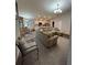 Inviting living space features open layout, seamlessly connected to kitchen, with modern lighting and cozy furnishings at 5547 Se 91St Pl, Ocala, FL 34480