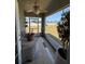 Relaxing screened porch with ceiling fan overlooking the expansive, well-maintained backyard at 5547 Se 91St Pl, Ocala, FL 34480