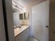Bathroom featuring a single sink vanity with white cabinets and light countertops at 5560 Metrowest Blvd # 3-204, Orlando, FL 32811