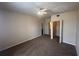Bedroom featuring neutral carpet with closet and bathroom doorway at 5560 Metrowest Blvd # 3-204, Orlando, FL 32811