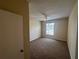 Bright bedroom featuring a ceiling fan, window, and neutral carpeting at 5560 Metrowest Blvd # 3-204, Orlando, FL 32811