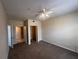 Bedroom featuring neutral carpet with closet and bathroom doorway at 5560 Metrowest Blvd # 3-204, Orlando, FL 32811