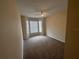 Carpeted bedroom has a ceiling fan and bright bay window at 5560 Metrowest Blvd # 3-204, Orlando, FL 32811