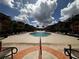 A full view of the community pool surrounded by lounge chairs, palm trees, and manicured grounds at 5560 Metrowest Blvd # 3-204, Orlando, FL 32811