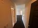 Inviting entryway featuring dark wood floors and neutral walls, leading to a bright living space at 5560 Metrowest Blvd # 3-204, Orlando, FL 32811