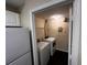 Practical laundry room with a washing machine and dryer is located next to the kitchen and refrigerator at 5560 Metrowest Blvd # 3-204, Orlando, FL 32811