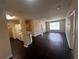 Open living space featuring wood floors, kitchen, and natural light at 5560 Metrowest Blvd # 3-204, Orlando, FL 32811