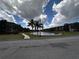 Scenic view of the community pond surrounded by lush landscaping and residential buildings at 5560 Metrowest Blvd # 3-204, Orlando, FL 32811
