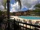 Exterior view of the luxurious community pool area featuring lounge chairs and a decorative gazebo at 5560 Metrowest Blvd # 3-204, Orlando, FL 32811