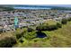 Aerial view of a Gathering-friendly neighborhood with a pond and walking trails surrounded by lush greenery at 605 Black Eagle Dr, Groveland, FL 34736