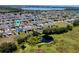 Aerial view showing a home's location within the community close to open green space, and a lake at 605 Black Eagle Dr, Groveland, FL 34736