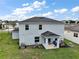 Rear exterior featuring a cozy covered patio and green lawn, perfect for relaxation and outdoor enjoyment at 605 Black Eagle Dr, Groveland, FL 34736