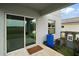 Back patio with sliding glass doors for indoor-outdoor living; features solar panels in background at 605 Black Eagle Dr, Groveland, FL 34736
