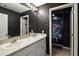 The modern bathroom features a double sink vanity and updated shower, offering both style and function at 605 Black Eagle Dr, Groveland, FL 34736