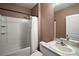 A functional bathroom featuring a shower-tub combination with white tile and neutral-toned walls at 605 Black Eagle Dr, Groveland, FL 34736