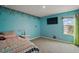 This colorful bedroom features cartoon decor and a large window for ample natural light at 605 Black Eagle Dr, Groveland, FL 34736